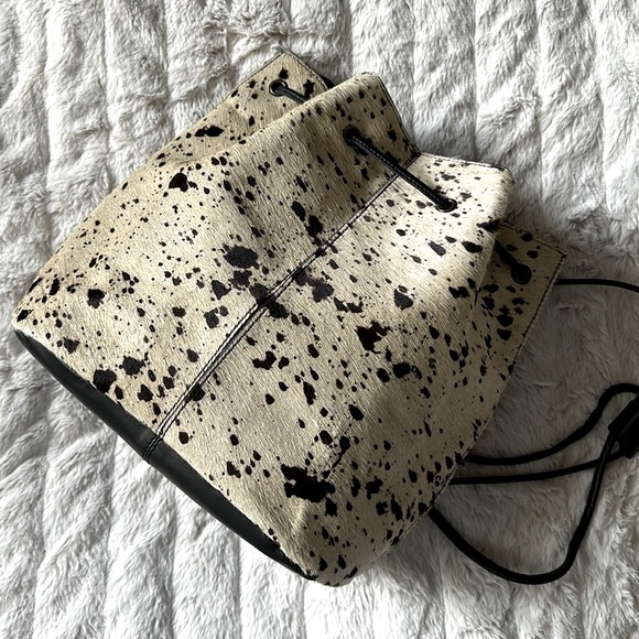 Urban Outfitters Handbags - Faux cowhide drawstring backpack‎